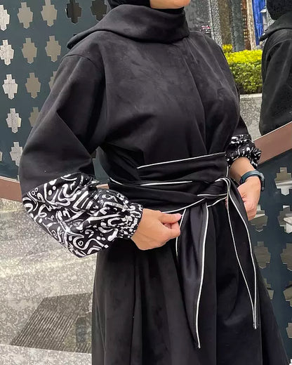 Suede jumpsuit with kuffi calligraphy